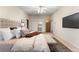 Main bedroom with a king-size bed, nightstand, and access to the bathroom at 665 S Alton Way # 6D, Denver, CO 80247