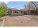 The backyard has a small patio with chairs and an exterior view of the house at 661 Tennyson St, Denver, CO 80204