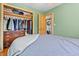 Bright bedroom featuring a closet with hanging storage and stacked laundry unit in a doorway at 661 Tennyson St, Denver, CO 80204