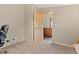 Bedroom featuring a wood door, neutral walls, and a glimpse into a room with a wooden dresser at 661 Tennyson St, Denver, CO 80204