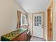 Bright entryway with a patterned tablecloth, natural light, and a paneled front door at 661 Tennyson St, Denver, CO 80204