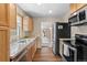Modern kitchen with stainless steel appliances, granite countertops, and ample storage at 661 Tennyson St, Denver, CO 80204