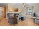Cozy living room featuring hardwood floors, a ceiling fan, and plenty of natural light at 661 Tennyson St, Denver, CO 80204