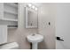 Bathroom featuring pedestal sink, white cabinets and a framed mirror with modern lighting at 4350 E 112Th Pl, Thornton, CO 80233