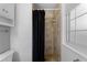 Tiled shower stall in bathroom featuring a dark shower curtain and a tiled floor at 4350 E 112Th Pl, Thornton, CO 80233