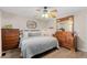 Cozy bedroom featuring wood flooring, a ceiling fan, two dressers, and natural light at 4350 E 112Th Pl, Thornton, CO 80233