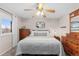 Bedroom featuring wood floors, a ceiling fan, and a comfortable bed with wood furnishings at 4350 E 112Th Pl, Thornton, CO 80233