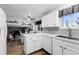 Bright kitchen featuring gray backsplash, stainless steel sink, and breakfast bar overlooking a living area at 4350 E 112Th Pl, Thornton, CO 80233