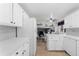 Modern kitchen featuring white cabinets, stainless steel appliances, and updated backsplash at 4350 E 112Th Pl, Thornton, CO 80233