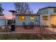 Brick patio with chairs and a table and view of home's windows, plus gas heater at 4350 E 112Th Pl, Thornton, CO 80233