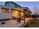 Covered back patio with outdoor seating, a fire pit, and overhead lighting at 4350 E 112Th Pl, Thornton, CO 80233