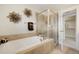 Relaxing bathroom features a soaking tub with a separate glass-enclosed shower at 5471 W 97Th Pl # F, Westminster, CO 80020