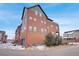 View of the exterior of a multi-story brick and siding townhome at 5471 W 97Th Pl # F, Westminster, CO 80020