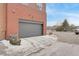 Attached garage with grey door and driveway at 5471 W 97Th Pl # F, Westminster, CO 80020