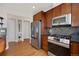 Modern kitchen featuring stainless steel appliances and rich hardwood cabinets at 5471 W 97Th Pl # F, Westminster, CO 80020