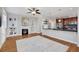 Inviting living room featuring a fireplace, built-in shelving, and open access to the kitchen at 5471 W 97Th Pl # F, Broomfield, CO 80020