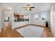 Bright living room features a ceiling fan and adjacent kitchen with bar seating at 5471 W 97Th Pl # F, Broomfield, CO 80020