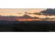 Scenic mountain view at sunset with soft pink and orange hues illuminating the sky over the distant peaks at 5471 W 97Th Pl # F, Westminster, CO 80020