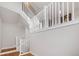 Bright, open staircase featuring white railings, hardwood floors, and natural light at 5471 W 97Th Pl # F, Broomfield, CO 80020