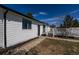 The backyard features a walkway, rock gardens, and a white fenced deck perfect for outdoor entertaining at 1266 S Telluride St, Aurora, CO 80017