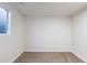 Finished basement showcases a clean, open space with neutral carpeting and a window, ready for customization at 1266 S Telluride St, Aurora, CO 80017