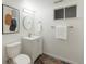 Bathroom featuring a modern vanity, decorative mirror, and patterned tile flooring, with neutral colored walls at 1266 S Telluride St, Aurora, CO 80017