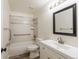 Bright bathroom features a white vanity, framed mirror, tiled shower-tub, and accessible grab bars for added safety at 1266 S Telluride St, Aurora, CO 80017