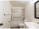 Bright bathroom features a white vanity, framed mirror, tiled shower-tub, and accessible grab bars for added safety at 1266 S Telluride St, Aurora, CO 80017