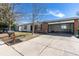 Charming single-Gathering home featuring a brick and white exterior, garage, and well-manicured front yard at 1266 S Telluride St, Aurora, CO 80017