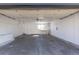 An empty two-car garage has storage shelving, a workbench and a door to outside at 1266 S Telluride St, Aurora, CO 80017