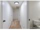 Hallway offers seamless flow with consistent carpeting, multiple doors, and adjacent bathroom at 1266 S Telluride St, Aurora, CO 80017