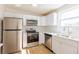 Bright kitchen featuring stainless steel appliances, white cabinets, and a modern subway tile backsplash at 1266 S Telluride St, Aurora, CO 80017