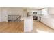Modern kitchen boasts stainless steel appliances, white cabinets, and a large island for extra seating at 1266 S Telluride St, Aurora, CO 80017