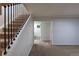 This living room features neutral walls, plush carpeting, staircase, and an inviting hallway to another room at 1266 S Telluride St, Aurora, CO 80017