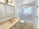 A bathroom featuring a vanity sink with a mirror and a shower with sliding glass doors at 1391 Vance St, Lakewood, CO 80214