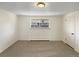 A standard carpeted bedroom with window and a door to the side at 1391 Vance St, Lakewood, CO 80214