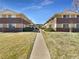 A brick apartment complex set among green lawns and a long walkway at 1391 Vance St, Lakewood, CO 80214