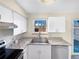 A modern kitchen with stainless steel appliances, white cabinetry, and stylish countertops at 1391 Vance St, Lakewood, CO 80214