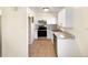 A well-lit kitchen featuring white cabinets and modern stainless steel appliances at 1391 Vance St, Lakewood, CO 80214