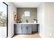 Contemporary bar area with light gray cabinetry and stylish backsplash at 2520 S Cherokee St, Denver, CO 80223