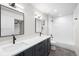 The bathroom offers double sinks, modern fixtures, and a shower-tub combination with white tile at 2520 S Cherokee St, Denver, CO 80223