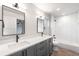 Bathroom with double vanity, modern fixtures, and a tub shower with subway tile at 2520 S Cherokee St, Denver, CO 80223