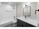 Well-lit bathroom with shower-tub combo and modern vanity at 2520 S Cherokee St, Denver, CO 80223