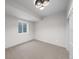 A bright bedroom with a modern ceiling light and a window at 2520 S Cherokee St, Denver, CO 80223