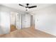Spacious bedroom with hardwood floors and open doorway to bathroom at 2520 S Cherokee St, Denver, CO 80223