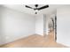 Minimalist bedroom with hardwood floors and doorway to staircase at 2520 S Cherokee St, Denver, CO 80223
