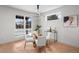 Bright dining room with modern lighting, a glass table, and an adjacent window at 2520 S Cherokee St, Denver, CO 80223