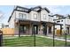 Charming two-story home with a well-manicured lawn, black metal roof, and a welcoming front porch at 2520 S Cherokee St, Denver, CO 80223