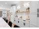 Contemporary kitchen featuring white cabinets, built-in storage, and a quartz countertop at 2520 S Cherokee St, Denver, CO 80223