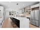 Modern kitchen with quartz counters, stainless appliances, and center island with bar seating at 2520 S Cherokee St, Denver, CO 80223